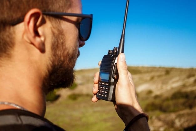 man talking walkie talkie radio enjoying canyon